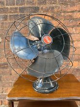 Load image into Gallery viewer, &quot;Image: Antique DIEHL MFG CO. Fan in working condition. Vintage metal fan with intricate grille design, capturing the charm of a bygone era and blending functionality with timeless craftsmanship.&quot;