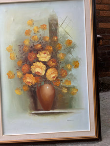 "Exquisite large framed oil painting of vibrant florals in shades of yellows and gold. Intricately detailed petals and dynamic play of light and shadow create a lifelike, three-dimensional effect. Ornate, elegant frame enhances the painting's grandeur and sophistication. A stunning blend of nature's beauty and artistic mastery."