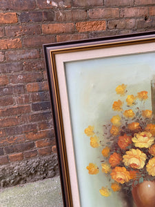 "Exquisite large framed oil painting of vibrant florals in shades of yellows and gold. Intricately detailed petals and dynamic play of light and shadow create a lifelike, three-dimensional effect. Ornate, elegant frame enhances the painting's grandeur and sophistication. A stunning blend of nature's beauty and artistic mastery."