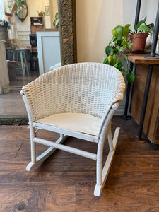 "Image: Vintage White 1940’s Child's Wicker Rocking Chair from Eaton’s Montreal. A charming miniature rocking chair with wicker weaving, showcasing nostalgic craftsmanship and a touch of history."