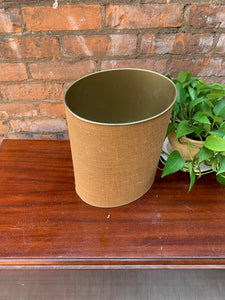 "Image: Vintage 1970s Trashcan with brass-colored tin interior and tweed exterior finish. A stylish and functional piece with retro charm, featuring a textured tweed exterior and durable brass-toned interior."