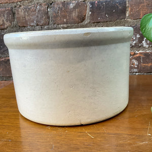 "Image: Antique crock with weathered surface and rustic charm. A piece of history, evoking nostalgia and authenticity. Versatile decor accent for farmhouse aesthetics and vintage collectors."