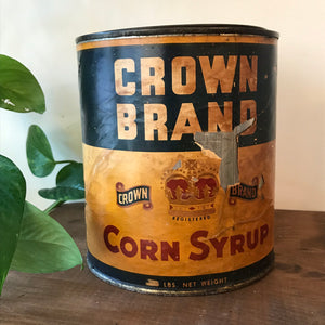"Image: Antique Crown Brand Corn Syrup Can - Vintage metal can with weathered label, embodying nostalgia and Americana history, evoking memories of traditional kitchen essentials."