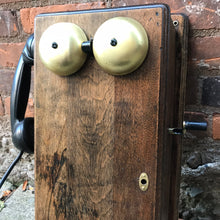 Load image into Gallery viewer, &quot;Image: Antique 1900s Northern Electric Wall Mount Crank Wood Cabinet Telephone. A vintage wood cabinet telephone with intricate detailing, crank mechanism, and brass accents, capturing the essence of a bygone era and serving as a functional conversation piece and decorative treasure.&quot;