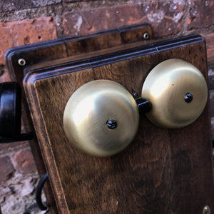 "Image: Antique 1900s Northern Electric Wall Mount Crank Wood Cabinet Telephone. A vintage wood cabinet telephone with intricate detailing, crank mechanism, and brass accents, capturing the essence of a bygone era and serving as a functional conversation piece and decorative treasure."