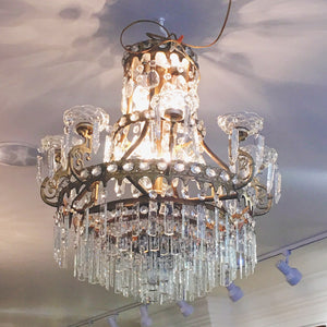 Image: Antique Empire Style Crystal Chandelier - A grand and ornate chandelier with cascading crystals, capturing the opulence of the Empire design era."